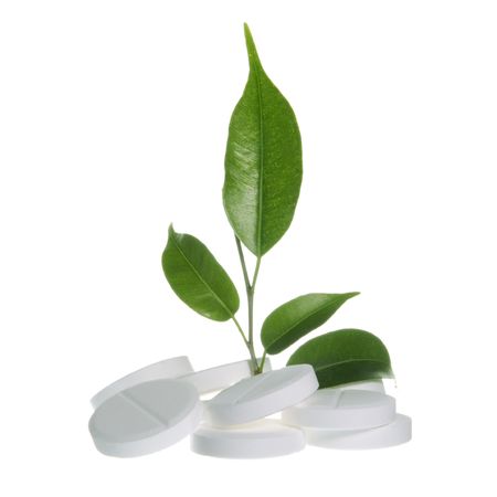 Pills with Leaf as Herbal Medicine Symbol on Whiteの写真素材