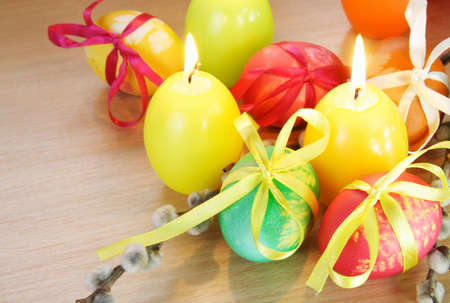 Easter Festive Decorations with Painted Eggs and Candlesの写真素材