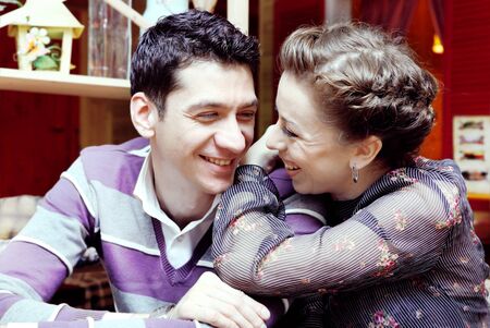 Young Lovers Smiling Couple in Cafe Portraitの写真素材