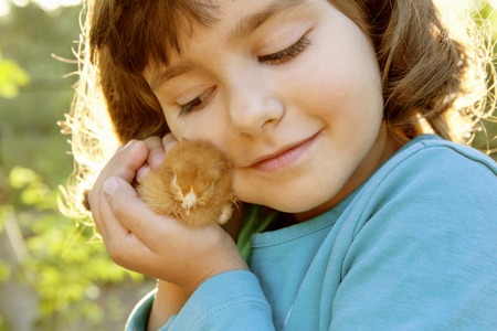 Affectionate Tender Girl Holding Chicken in Hands Like a Treasure