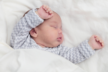 Cute newborn baby boy sleeping, hands upの写真素材