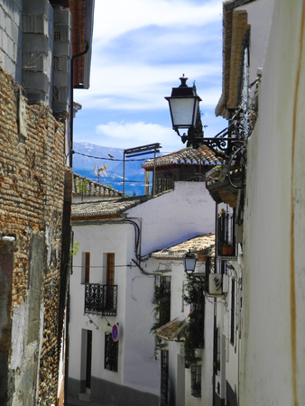 Albaicin, Old muslim quarter, district of Granada in Spain. Narrow street with white houses. Blue summer sky.の写真素材