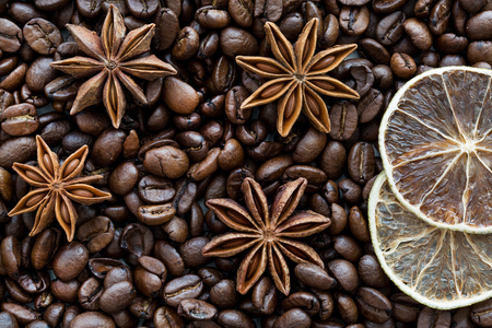 Coffee beans, anise stars and dried lime slices, close up, macro. Christmas concept.の写真素材