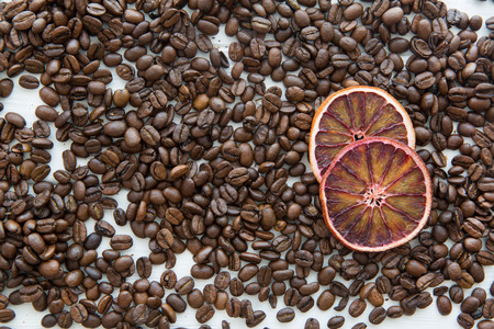 Coffee beans and dried sicilian orange slice, christmas mood concept, top view, white wooden background.の写真素材