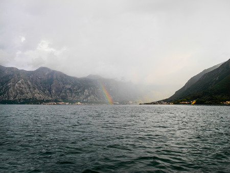 Green sea landscape and mountains, rainy day and sunshines.の写真素材