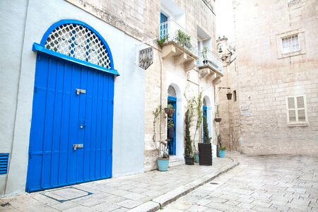 Malta blue door and white walls, street typical Maltese archtecture. 