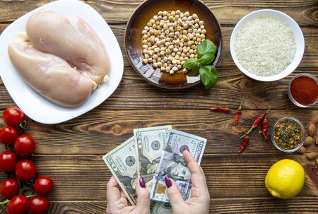 Expensive protein rich food, USD dollar banknotes. Natural chicken meat, chick-pea and rice. Healthy nutrition. の写真素材