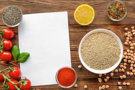 Healthy vegetarian food background, copy space. Raw quinoa, chickpeas and spices on brown rustic...