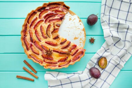 Delicious fruit pie with cream on turquoise table, tasty summer dessert, top view.  の写真素材