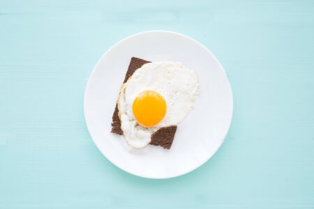 Tasty toast with fried eggs, copy space, top view. の写真素材