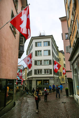 Zurich, Switzerland -16 April 2017. Narrow old stree, decorated with flags.のeditorial素材