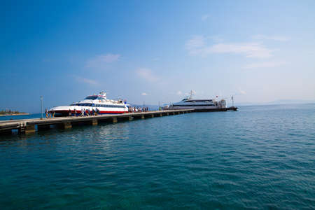 Kos, Greece - 27 July 2018. Kos island harbor port with boats and big ships. Cruise touris big ships and small cruise ships.のeditorial素材