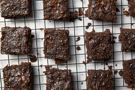 Tasty chocalate brownie on baking rack, top view.