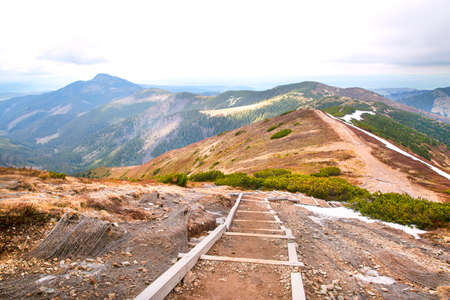 Hiking on a mountains, path on the top. Summertime vacations.