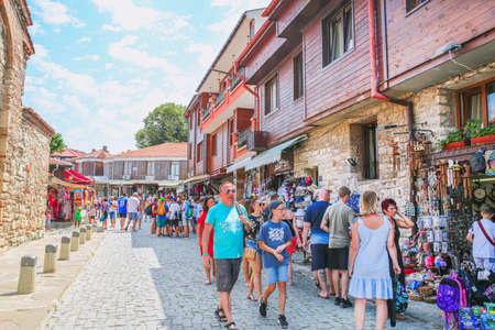 29 of July 2019, Nessebar Bulgaria. Souvenir shops with clothers, magnets and post cards, a lot of people.のeditorial素材