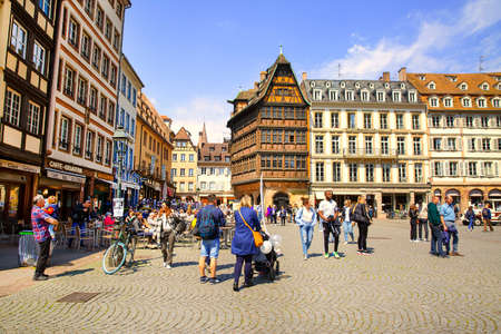 2 of May 2022, Strasbourg, France. Square near cathedral, the Kammerzell House, a lot of shops and restaurants, walking people and tourists.のeditorial素材