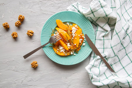 Baked pumpkin slices with cottage cheese and nuts, top view. Warm autumn colors.の写真素材