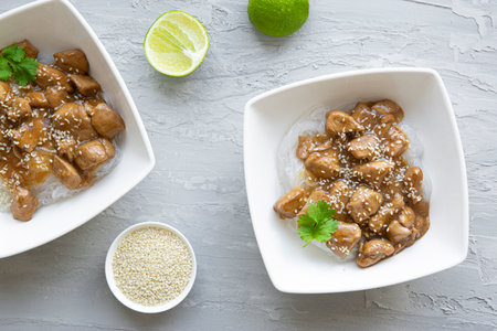 Thai noodles with meat, lime and cilantro on gray concrete background, top view.の写真素材
