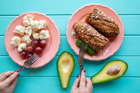 Concept of healthy food and diet. Plate with fresh sandwiches and fruit and vegetable, top view.の写真素材