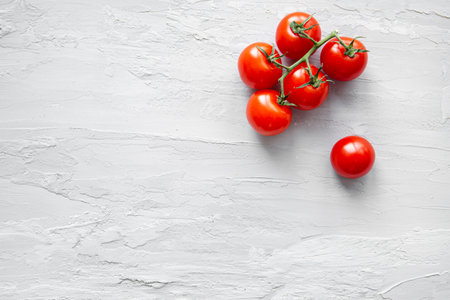 Fresh cherry tomatoes on gray background, top view. Copy space, space for text.の写真素材