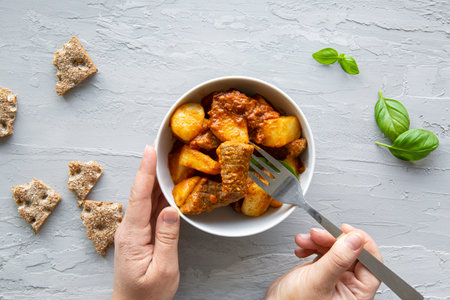 Beef stew with potatoes on gray background, top view.の写真素材
