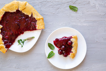 A piece of tasty cherry galette on gray background, top view.の写真素材