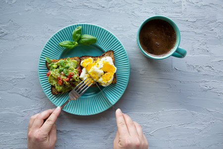 Healthy conceptual snack, sandwiches with avocado and egg and a cup of coffee, top view.の写真素材