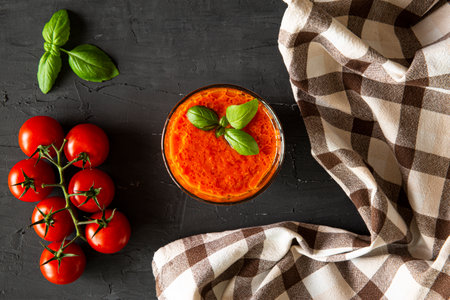 Tomato soup on black background, top view.の写真素材