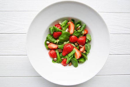 Tasty summer strawberry salad on white background, top view. Healthy diet dish.の写真素材