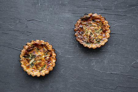 Quiche with asparagus and cheese on black marble background, top view.の写真素材