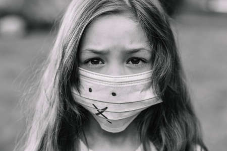 A girl in a medical mask from protection against covid-19.の写真素材