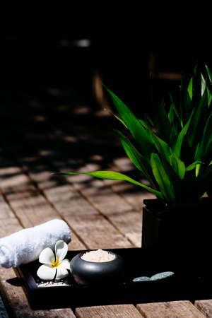 Balinese spa setting, white frangipani with sea salt and fresh coconut. Hot Stone Massage Set. White massage towels.の写真素材