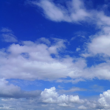 Blue sky background with white clouds, white clouds in the blue skyの写真素材