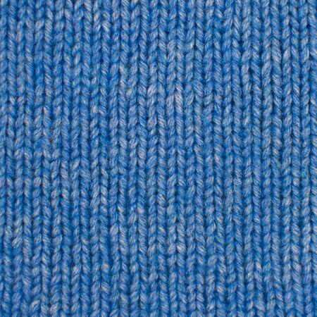 Needlework, hobbies, knitting. Background textile fabric with a knitted texture wool blue. Blue knitted fabric texture. Hand knitting.の写真素材