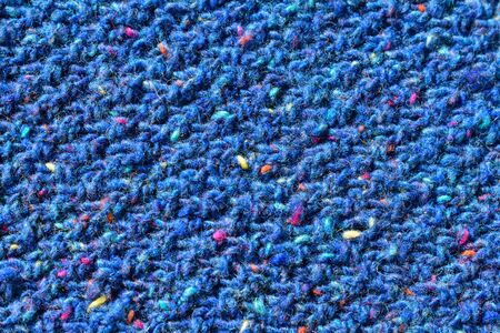 Wool sweater texture close up. Abstract knitted background texture, knitted by hand. Blue cloth with diagonal stripes knitted by handの写真素材