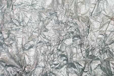 Silver gray background. Silver background with shiny uneven surface. Background for design and...