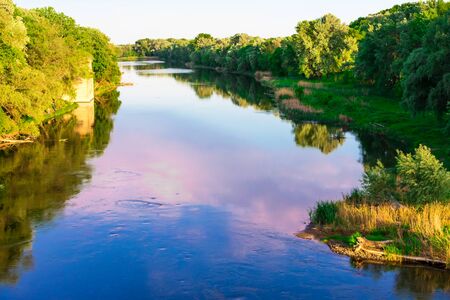 River in the forest in the rays of the setting sun. Seversky Donets. Lysychansk. Severodonetsk....