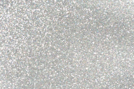 Silver abstract background with bokeh defocused christmas lights. Holiday concept. Selective focus.の写真素材