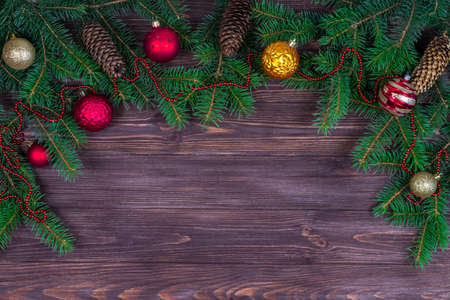 Christmas tree with decoration on a dark wooden background. View from above. Place for an inscription. New Year. Christmasの写真素材