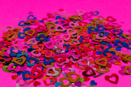 Pink background with colorful hearts. Love concept, Valentines Day greeting card. The basis for the...