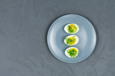 Microgreens on eggs. Decorate the salad with microgreen leaves. Diet food. Boiled and fresh eggs...