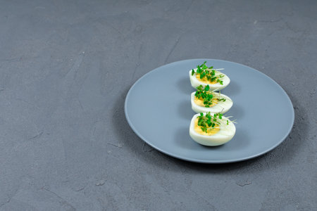 Microgreens on eggs. Decorate the salad with microgreen leaves. Diet food. Boiled and fresh eggs...