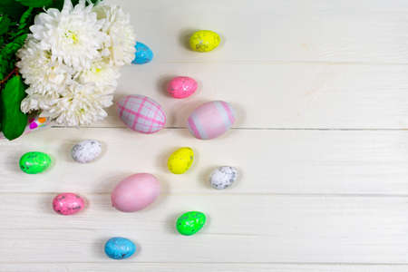 Colorful easter eggs flowers on pastel background with copy space. Flat lay.の写真素材