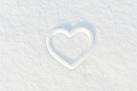 Heart on white snow. Place for an inscription. The basis for the postcard.の写真素材