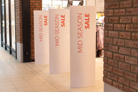 Bright white advertising banner at the entrance to the mall. Offer of seasonal discounts in the storeの写真素材