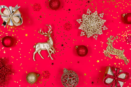 New Year and Christmas banner. Decorative Christmas toys, snowflakes, deer, balls and gift boxes on a red background.の写真素材