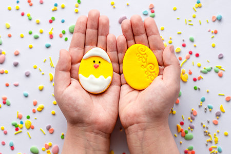 Confectionery, sweets for the Easter table in the hands of a child. Easter concept.
