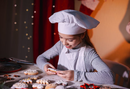 A girl enjoys Christmas cookies. Merry Christmas and happy holidays.の写真素材