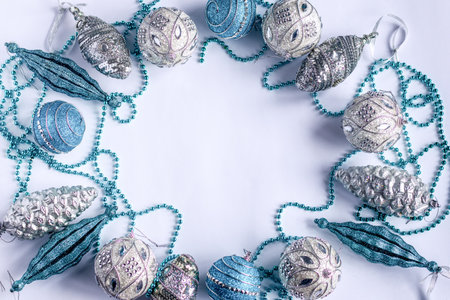 Christmas decorations with blue and silver ornaments and beads on a white background. Copyspaceの写真素材
