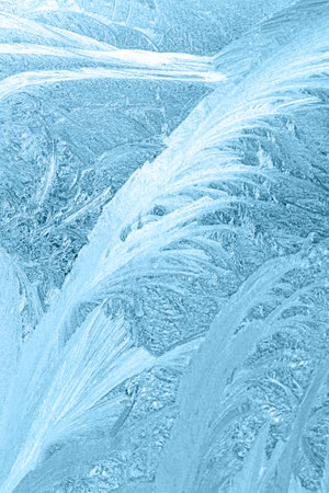 Abstract icy patterns resembling frost on a window glass surface